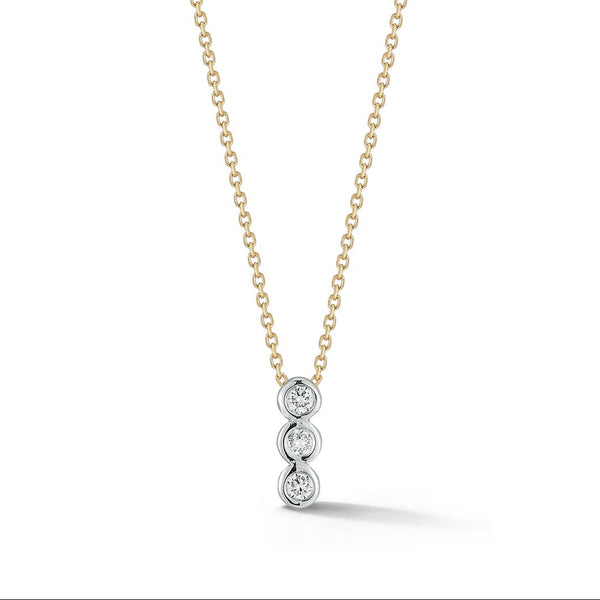 Gold necklace with a three-stone diamond pendant on a white background